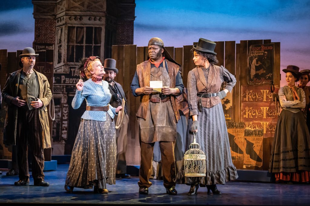 Stephen K Amos as Alfred P Doolittle with the company of My Fair Lady. Credit Marc Brenner