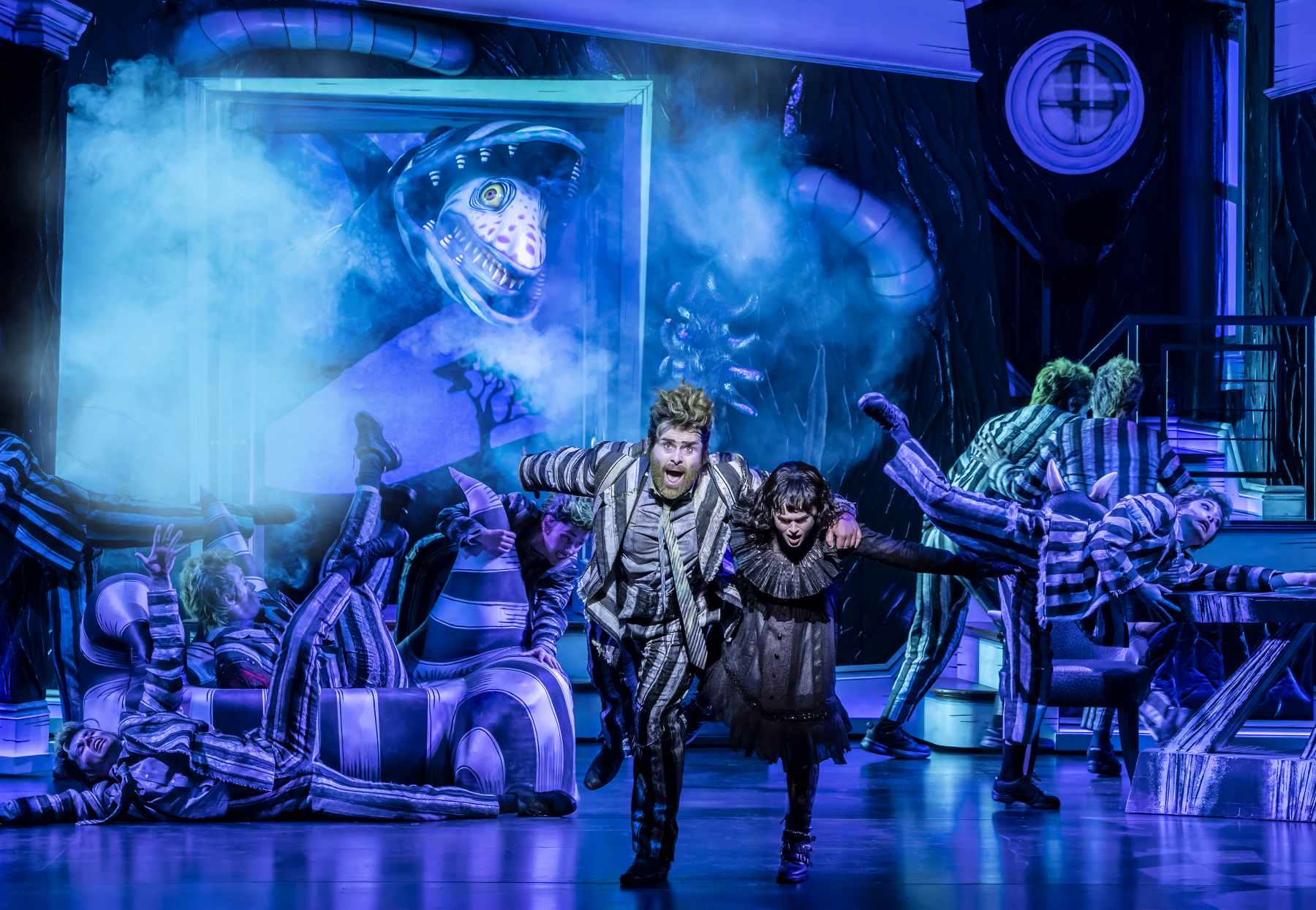 Beetlejuice the Musical – review 1 David Fynn as Beetlejuice and Hannah Nordberg as Lydia Deetz with Company © Johan Persson